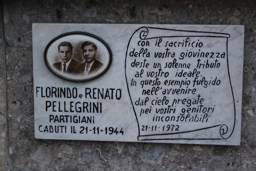 Monumento ai fratelli Pellegrini, dedizione ai caduti partigiani con una targa commemorativa e ritratti.