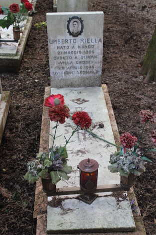 Tomba con lapide di Umberto Riella, fiori e lumini in memoria dei caduti per la libertà.