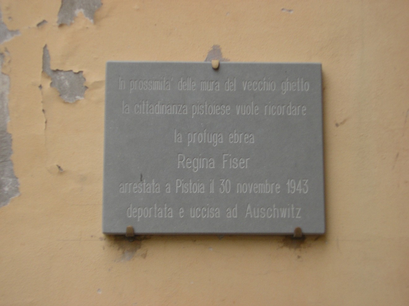 Lapide che ricorda Regina Fiser, deportata ad Auschwitz nel 1943, presso le mura del ghetto di Pistoia.