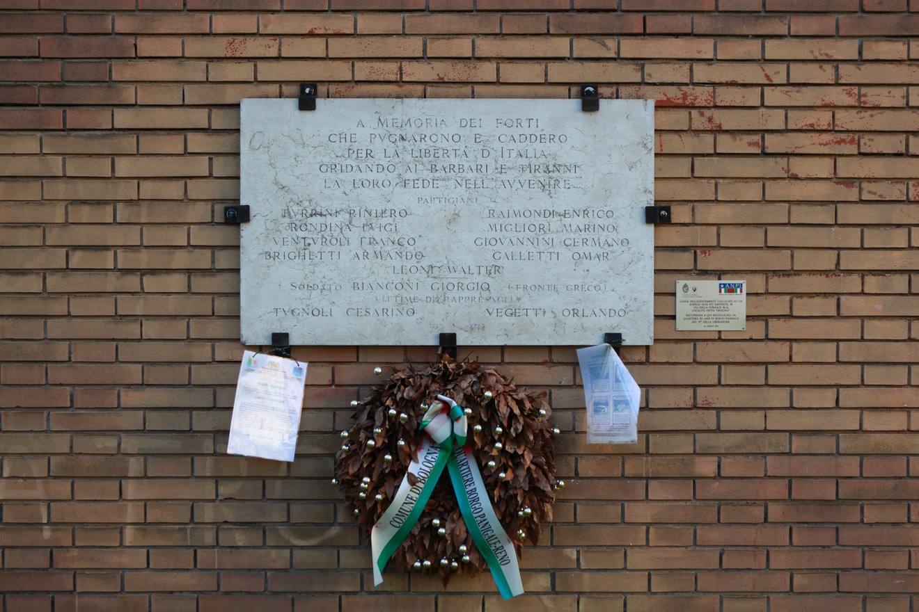 Lapide commemorativa con corona di fiori, dedicata ai caduti per la libertà a Savegna.