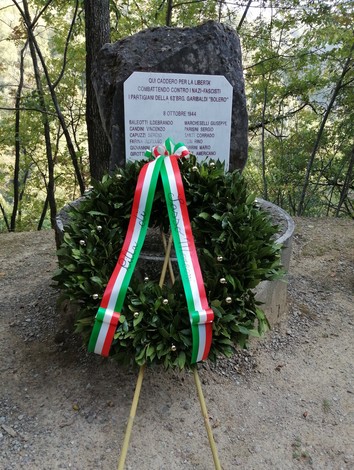 Monumento commemorativo con una corona di alloro e un basamento in pietra dedicato ai caduti della Brigata Bolero.