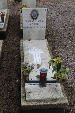 Tombe in memoria dei caduti per la Libertà, con fiori e lumini commemorativi.