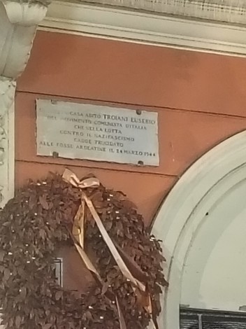 Lapide commemorativa dedicata a Eusebio Troiani, attivista comunista, situata su un edificio.
