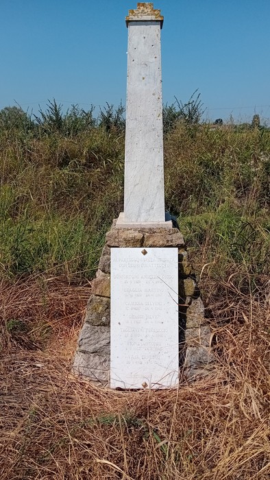 Cippo commemorativo dedicato ai sette partigiani di Breda Cisoni, immerso nella natura circostante.