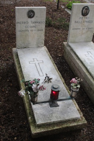 Tombe perpetue con lapidi bianche, fiori e candele in memoria dei caduti per la Libertà.