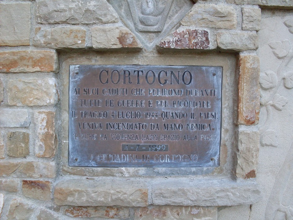 Targa commemorativa dedicata ai caduti e all'incendio del paese di Cortogno. Memoria e rispetto per il passato.