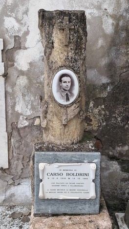 Cippo commemorativo dedicato a Carlo Boldrini, con foto e iscrizioni in ricordo della sua vita.