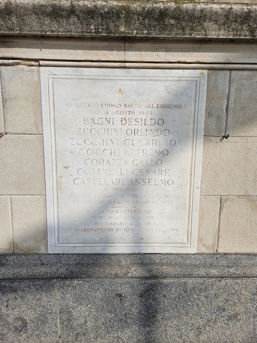 Lapide commemorativa dedicata ai fucilati della Montagnola, con iscrizioni memoriali su pietra.