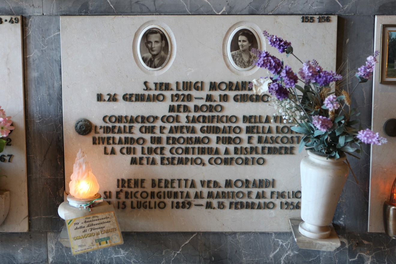 Sepolcro di Luigi Morandi, con foto e memento, decorato con fiori e lumino. Rappresenta un atto di memoria e rispetto.