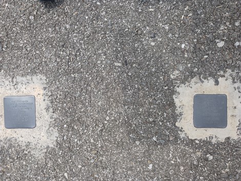 Pietre d'inciampo dedicate a Brambilla e Cavenaghi su un marciapiede in una strada.