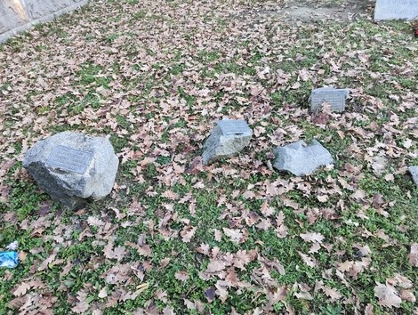 Monumento ai caduti della Liberazione, con pietre commemorative immerse in un tappeto di foglie secche.