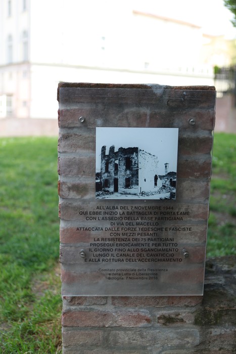 Targa commemorativa che ricorda la resistenza partigiana a Porta Lame, con foto storica e informazioni dettagliate.