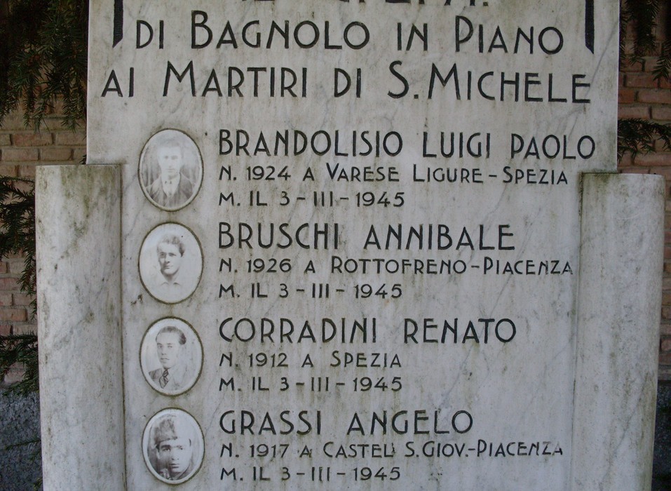 Monumento dedicato ai martiri di S. Michele a Bagnolo in Piano, con nomi e date commemorative.