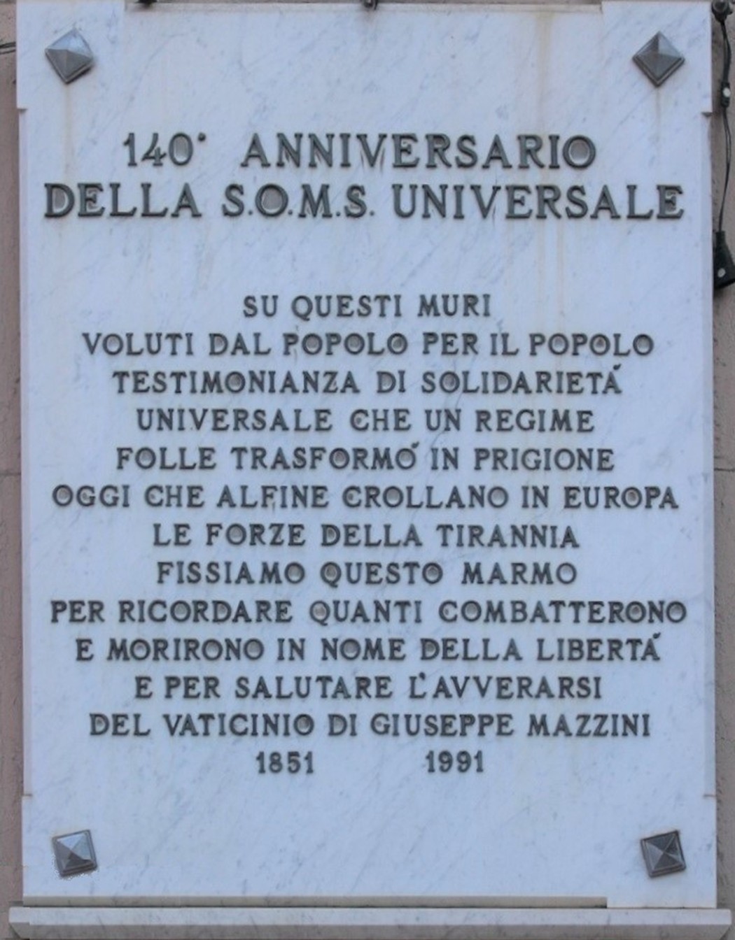 Lapide commemorativa dedicata ai combattenti per la Libertà, con iscrizioni storiche e messaggi di memoria.
