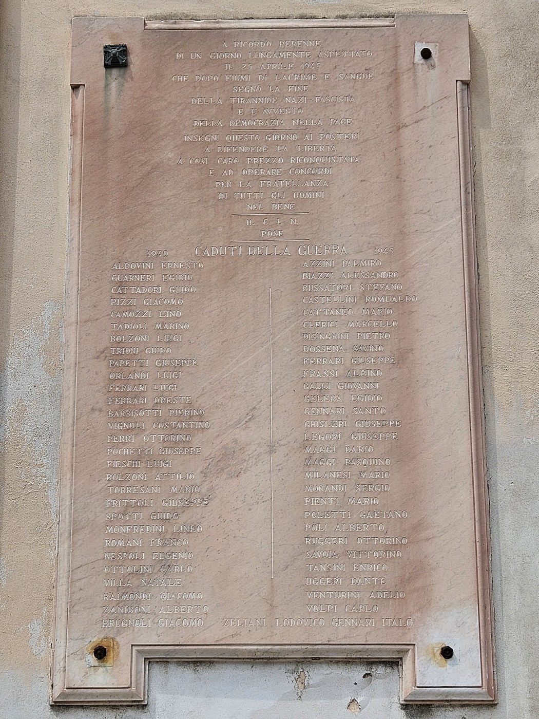 Lapide commemorativa con i nomi dei caduti della guerra 1940-1945, affissa su una superficie murale.