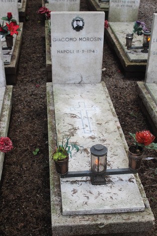 Tombe perpetue dei caduti per la Libertà con decorazioni floreali e lumini.