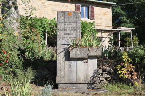 Monumento commemorativo a Pinzani e Pasquini, situato in un contesto naturale e rurale.
