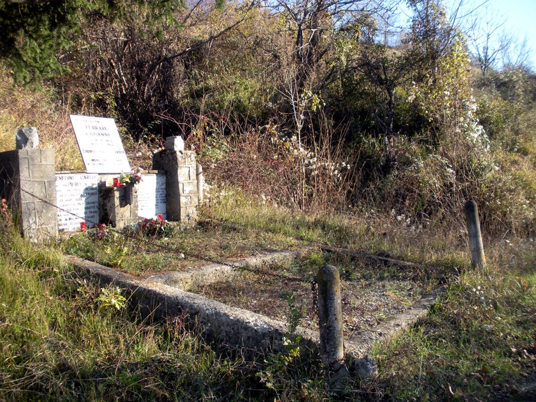 Monumento commemorativo dedicato a Ferrari, Benedini e Casotti, immerso nella natura circostante.