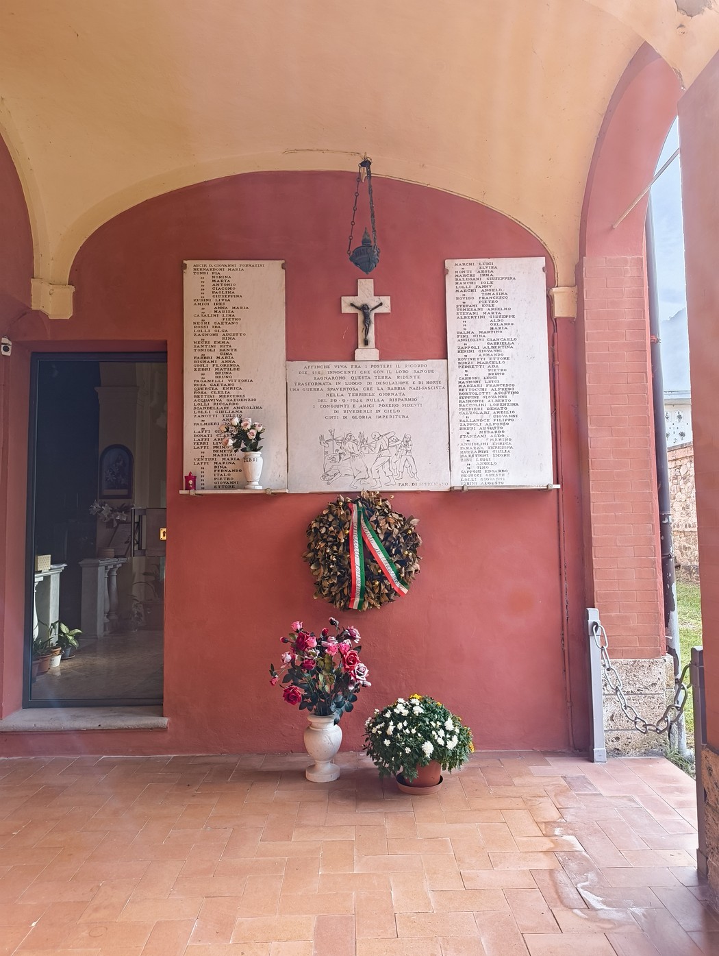 Lapidi commemorative dedicate agli uccisi di Sperticano, con fiori e decorazioni in segno di memoria.