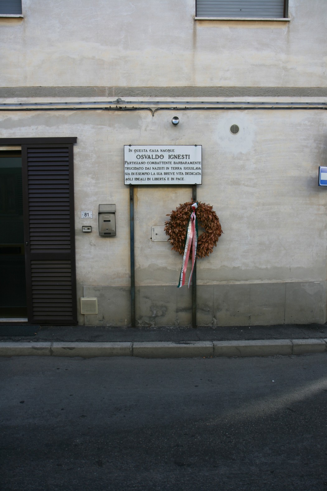Lapide commemorativa dedicata a Osvaldo Ignesti, affissa su una parete.