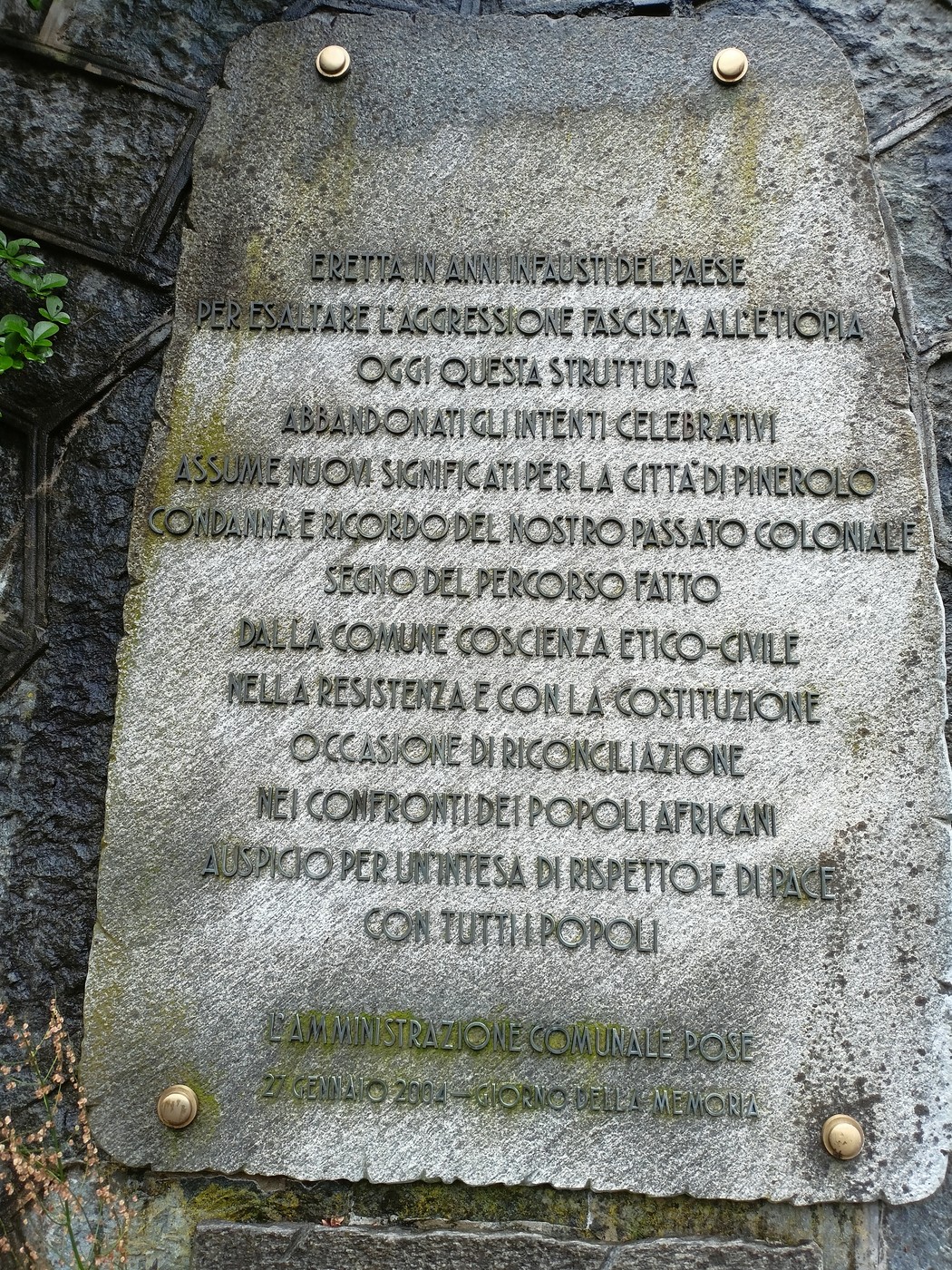 Lapide che commemora le vittime delle guerre coloniali, con un richiamo alla memoria storica e alla resistenza.