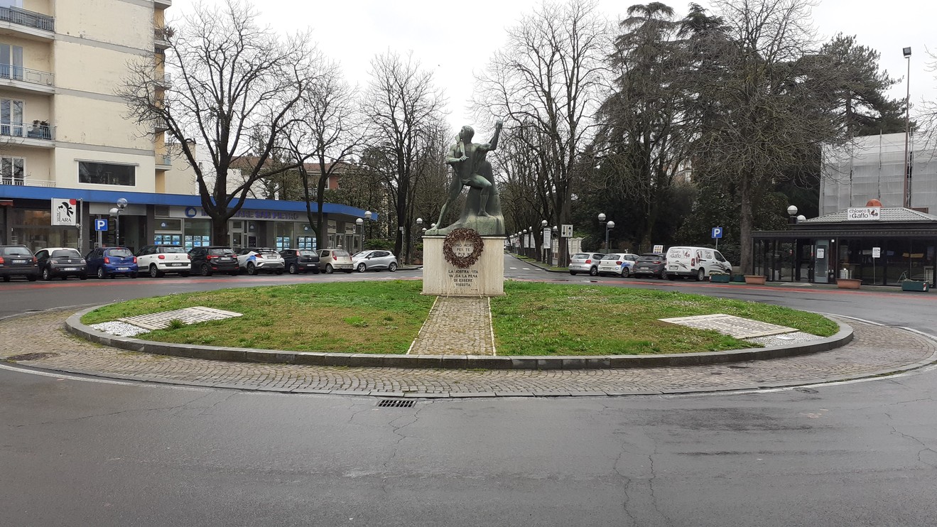 Monumento al Partigiano, simbolo di resistenza e libertà, situato in una rotonda circondata da verde urbano.