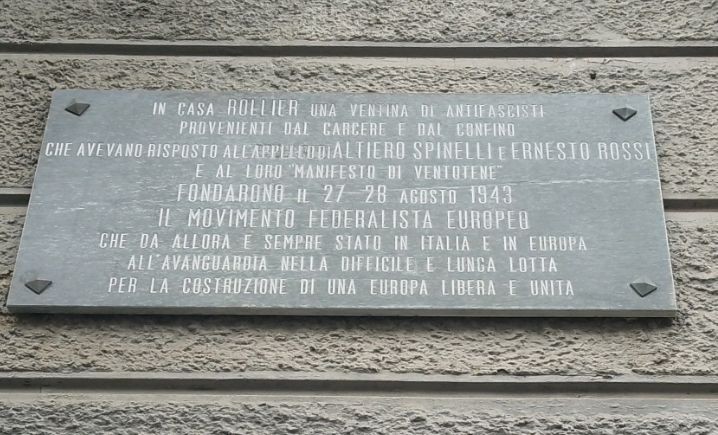 Lapide in marmo con iscrizione, fissata alla parete esterna di un edificio.