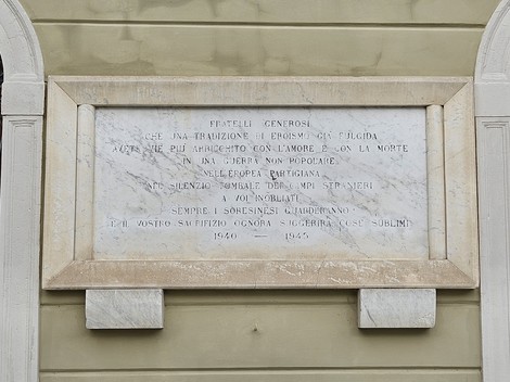 Lapide commemorativa dedicata ai caduti per la libertà, con incisioni su marmo e un design sobrio.