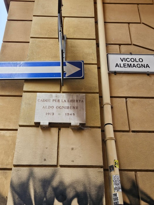 Lastra commemorativa di Aldo Ognibene, caduto per la libertà, situata all'incrocio di due vie.