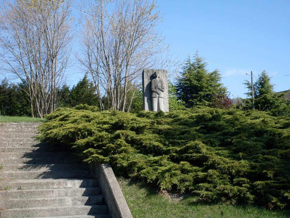 Monumento ai Caduti di Felina, dedicato alla memoria dei soldati, immerso nel verde e circondato da alberi.