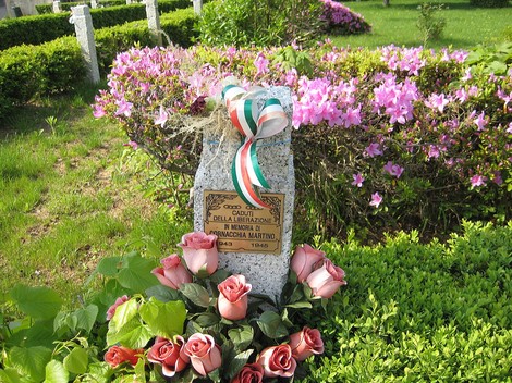 Cippi del Parco della Rimembranza, dedicati ai caduti, con fiori e decorazioni tricolori.
